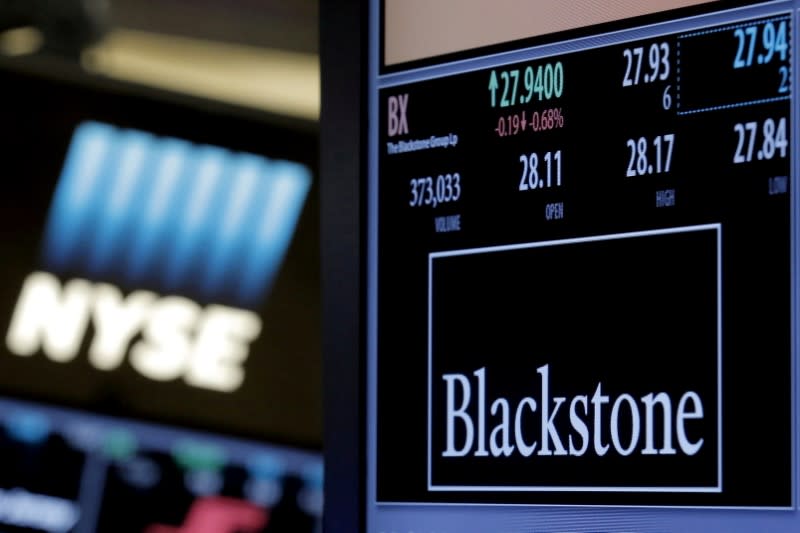 FILE PHOTO: The ticker and trading information for Blackstone Group is displayed at the post where it is traded on the floor of the New York Stock Exchange