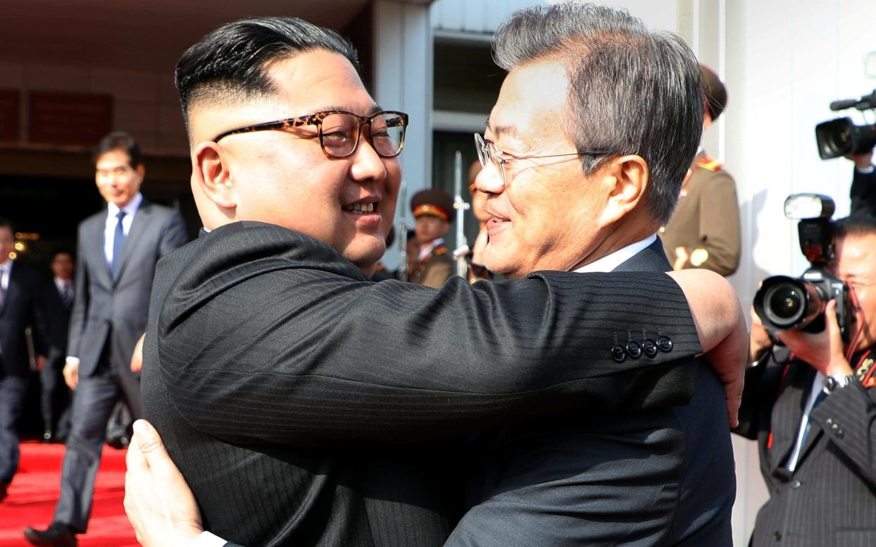 President Moon Jae-in bid farewell to Kim Jong-un with a triple hug after their summit at the truce village of Panmunjom on Saturday - REUTERS