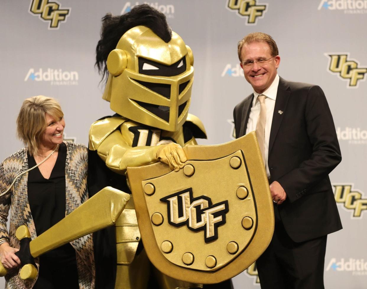 UCF football coach Gus Malzahn, seen here with team mascot Knightro and his wife, Kristi, at his introductory press conference, will have a huge opportunity to upgrade his program with the school gaining Power 5 status as a new member of the Big 12 Conference.