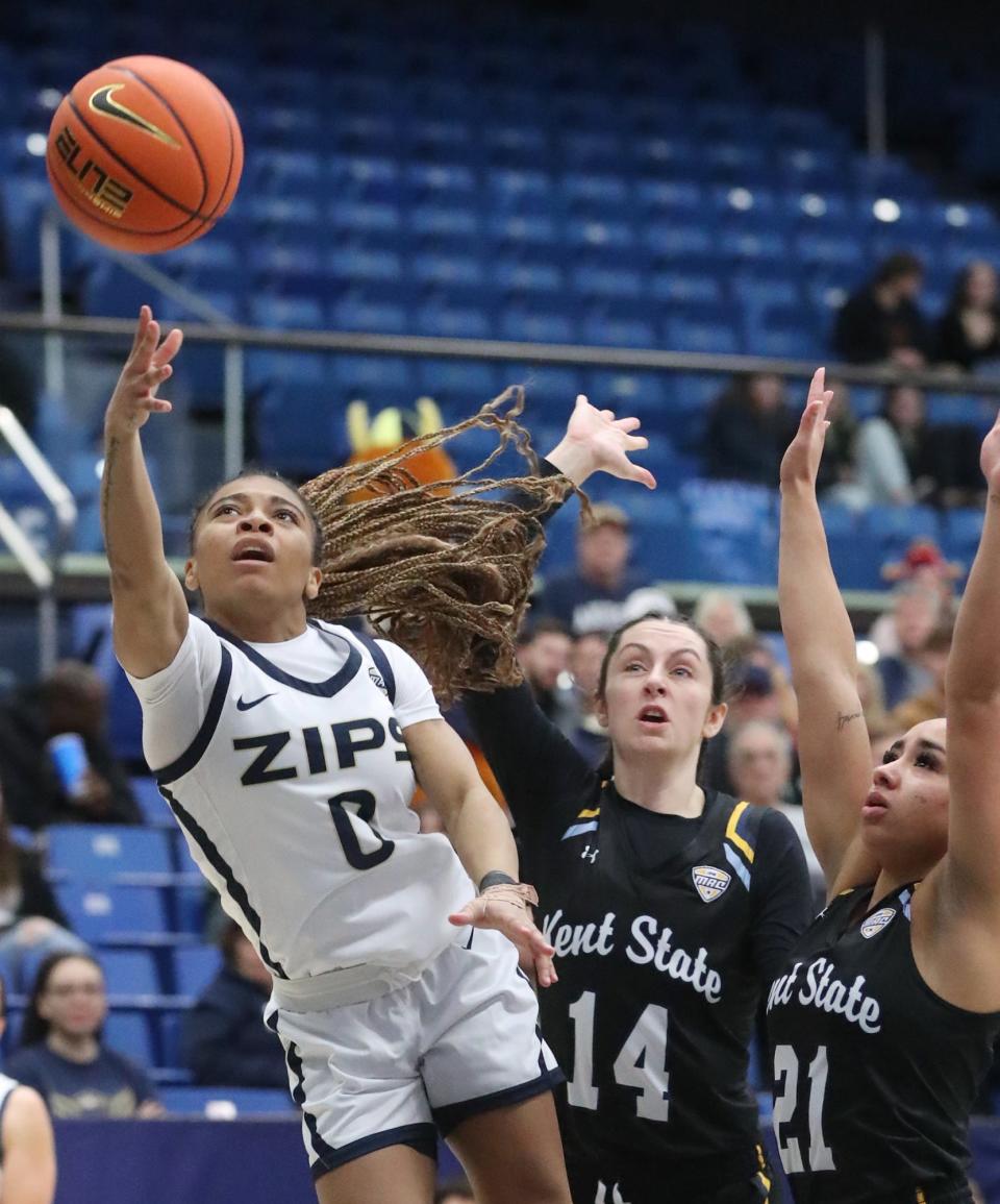 Akron's Kaia Woods shoots as Kent State's Katie Shumate and Dionna Gray defend in the first half Saturday in Akron.