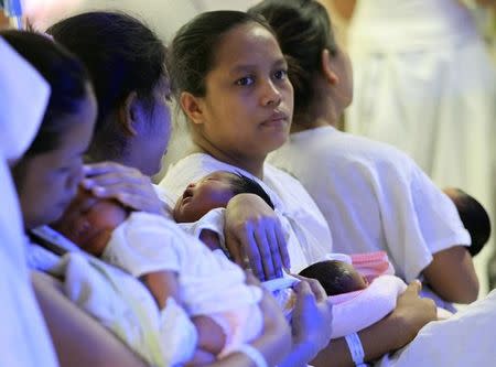 Mothers and their newborn babies wait for their checks-up inside the Fabella hospital, dubbed as the busiest maternity hospital in the country, in Manila, Philippines February 16, 2016. REUTERS/Romeo Ranoco