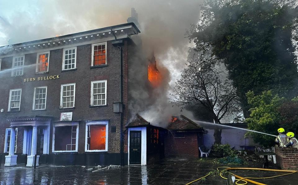 Firefighters hose down the pub as they try to extinguish the flames