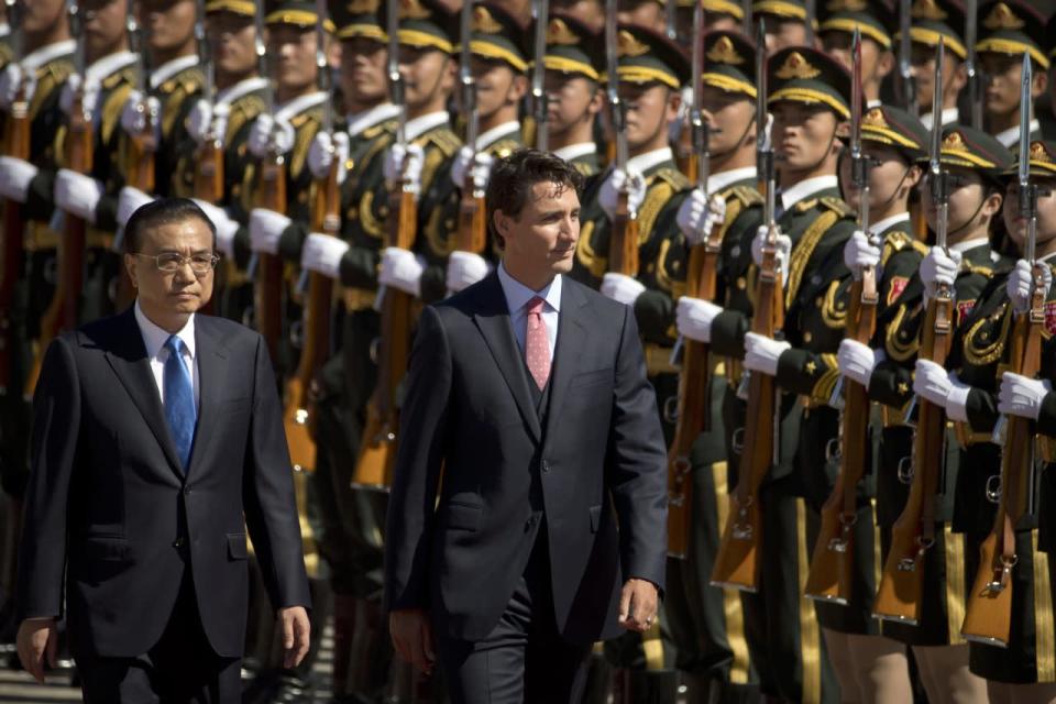 China’s Premier Li Keqiang and Prime Minister Justin Trudeau review an honor guard during a welcome ceremony at the Great Hall of the People in Beijing, China, on Aug. 31, 2016. (AP Photo/Mark Schiefelbein)