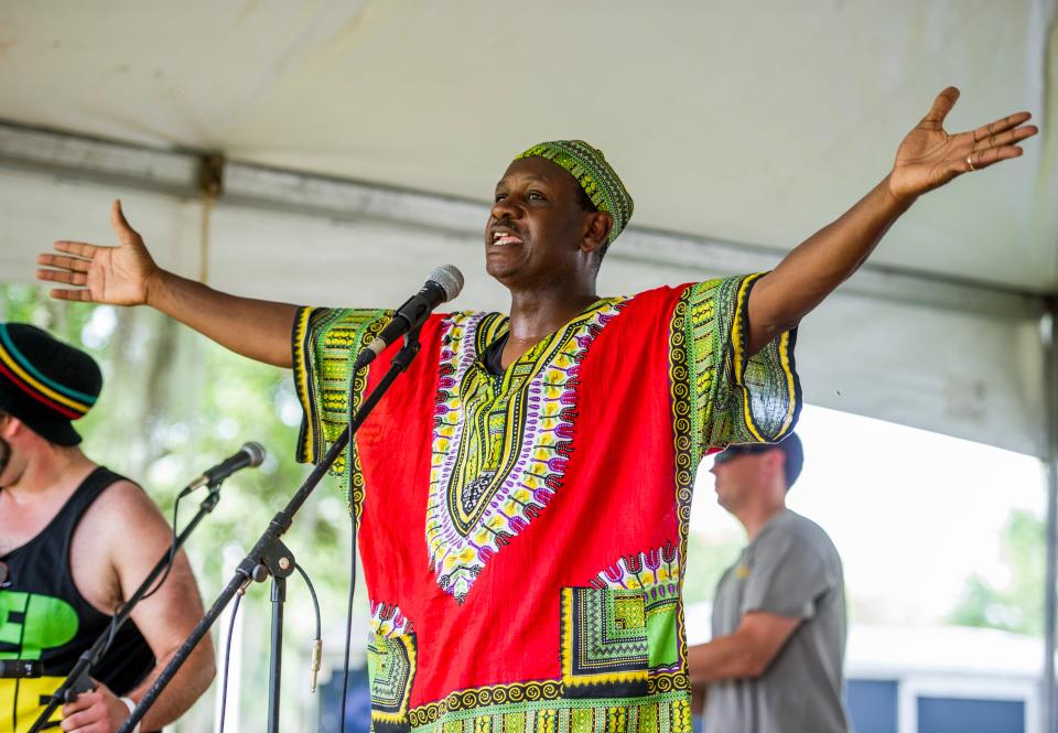 The Rev. Abram Freeman, a festival organizer, welcomes guests to the Southwest Louisiana Juneteenth celebration at Henry Heymann Park in Lafayette, La., Sunday, June 21, 2015.
