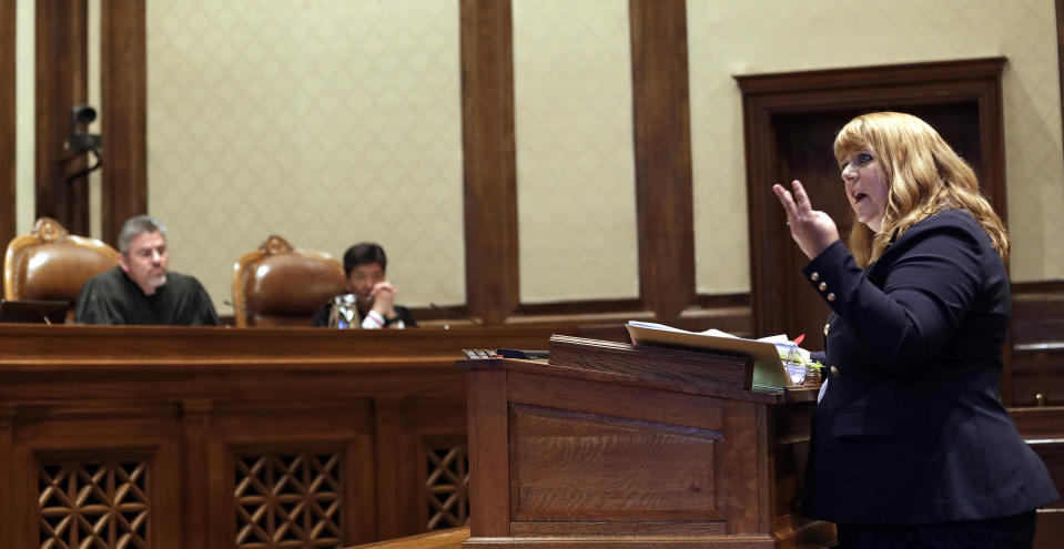 Michele Earl-Hubbard, attorney for the media coalition, addresses the Washington Supreme Court as Justice Steven C. Gonzalez, left, and Justice Mary I. Yu look on during a hearing Tuesday, June 11, 2019, in Olympia, Wash. The court heard oral arguments in the case that will determine whether state lawmakers are subject to the same disclosure rules that apply to other elected officials under the voter-approved Public Records Act. The hearing before the high court was an appeal of a case that was sparked by a September 2017 lawsuit filed by a media coalition, led by The Associated Press. (AP Photo/Elaine Thompson)