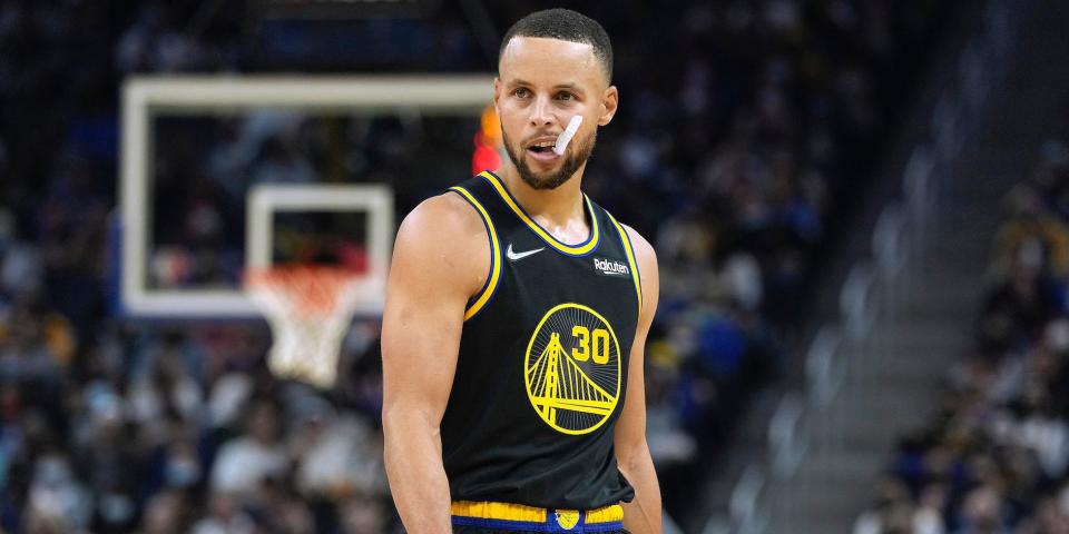 Stephen Curry stares down the the court while chewing his mouthguard.