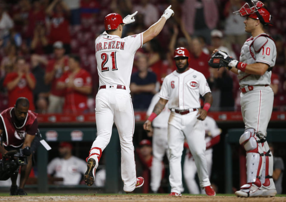 Cincinnati Reds' Michael Lorenzen (21) reacts as he crosses the plate with a two-run home run off Philadelphia Phillies relief pitcher Blake Parker during the eighth inning of a baseball game Wednesday, Sept. 4, 2019, in Cincinnati. (AP Photo/Gary Landers)