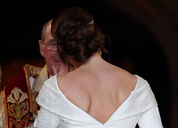 The back of Princess Eugenie's dress, which is cut low to show her scar.