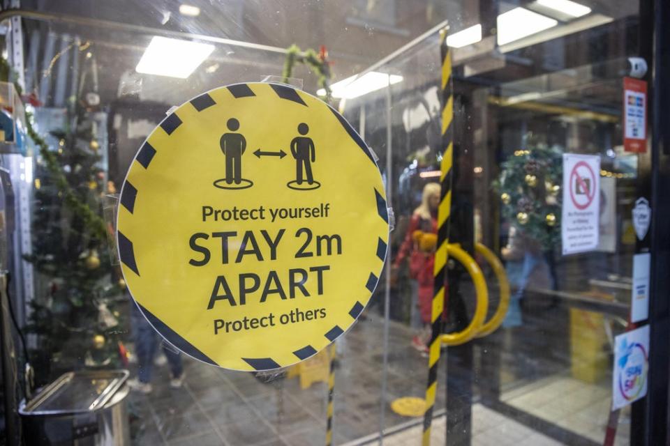 Signage on the window of Pic and Mix Body Jewellery Shop in Belfast asking customers to social distance and protect yourself and others by staying 2m apart. (Liam McBurney/PA) (PA Wire)