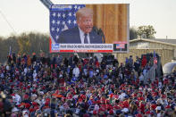 A throng of supporters listen to a video message as they await President Donald Trump for a campaign stop, Saturday, Oct. 31, 2020, at the Butler County Regional Airport in Butler, Pa. (AP Photo/Keith Srakocic)