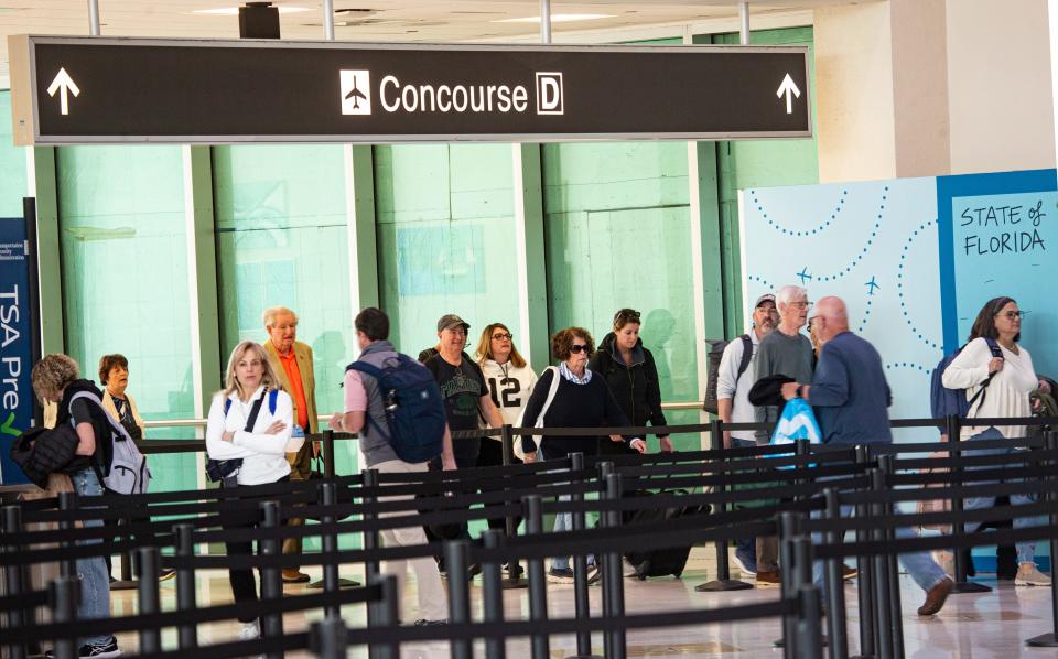 Travelers leave a concourse after landing at Southwest Florida International Airport in Fort Myers on Friday, March 1, 2024.