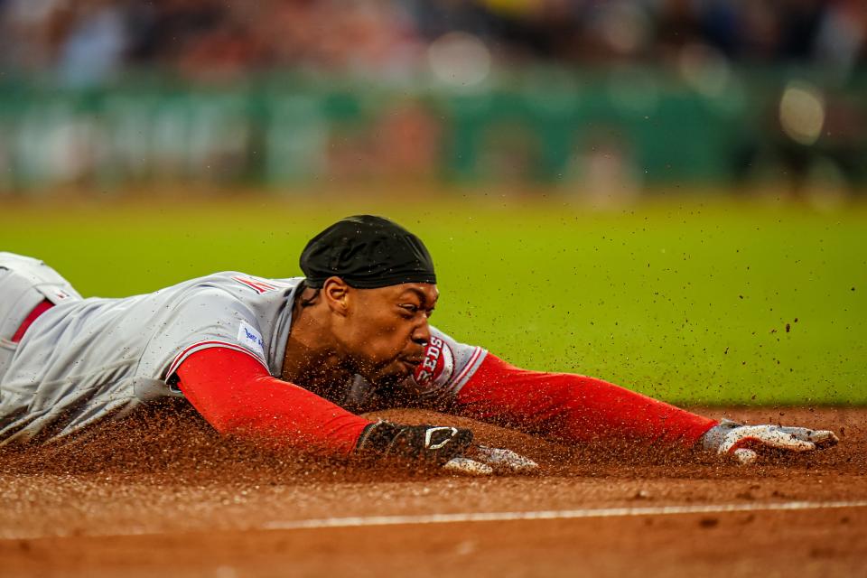 May 30, 2023;  Boston, Massachusetts, USA;  Cincinnati Reds center fielder Will Benson (30) hits a triple against the Boston Red Sox in the fourth inning at Fenway Park.