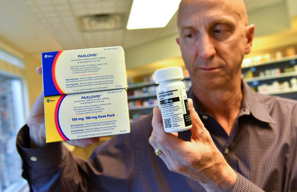 Dr. George Morris holds samples of oral COVID-19 anti-viral medication Thursday, May 19, 2022, at the St. Cloud Hospital outpatient pharmacy.