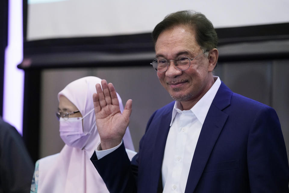 Malaysia's opposition leader Anwar Ibrahim waves after a press conference in Kuala Lumpur, Wednesday, Sept. 23, 2020. Anwar said he has secured a majority in parliament to form a new government that is “strong, stable and formidable." (AP Photo/Vincent Thian)