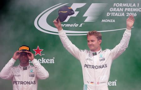 Formula One - F1 - Italian Grand Prix 2016 - Autodromo Nazionale Monza, Monza, Italy - 4/9/16 Mercedes' Nico Rosberg celebrates his win on the podium after the race as Lewis Hamilton looks on Reuters / Max Rossi Livepic