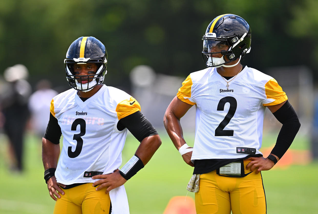 Justin Fields, right, is in line for his second straight start over an injured Russell Wilson. (Joe Sargent/Getty Images)