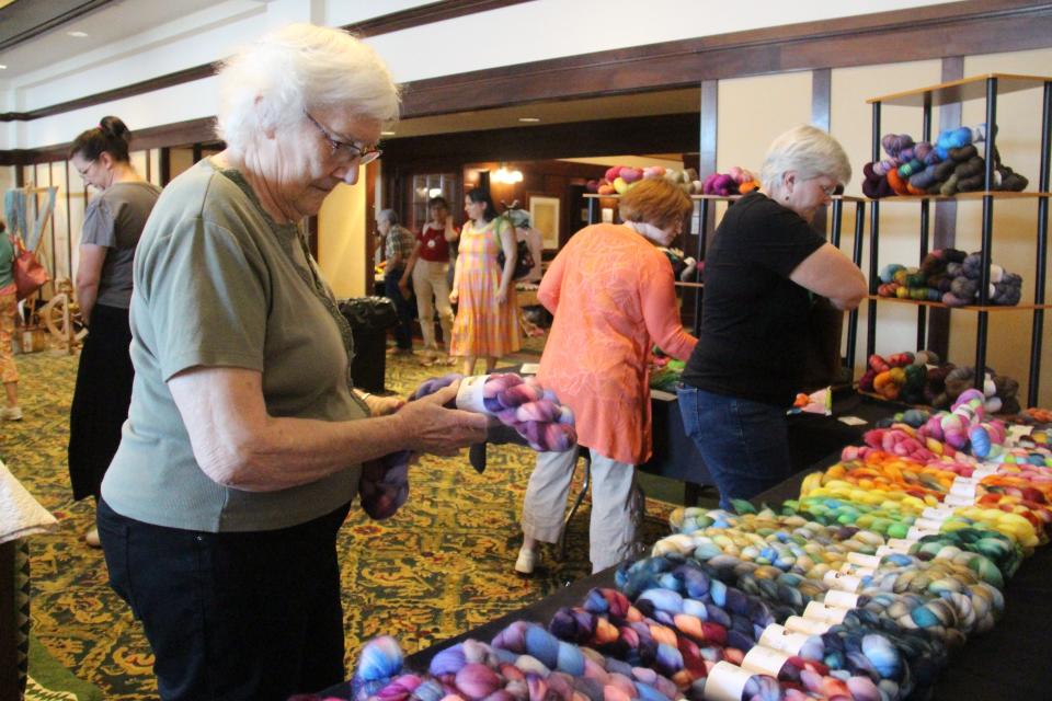 Janice Cook, of Monroe, checks out yarn at the Bombshell Dyeworks booth during the Fiber Festival of Perry on Saturday, May 14, 2022, at the Hotel Pattee.