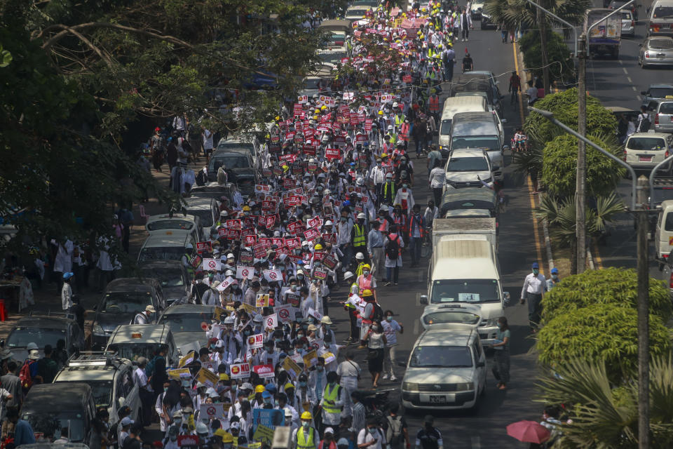 FILE - Anti-coup protesters march in Yangon, Myanmar, Thursday, Feb. 25, 2021. Facebook's recommendation algorithm amplifies military propaganda and other material that breaches the company's own policies in Myanmar even though the social media giant says it’s treating the situation there as an emergency following February's military coup, a new report by the rights group Global Witness has found. A month after the military seized power in Myanmar and imprisoned elected leaders, Facebook's algorithms were still prompting users to view and “like” pro-military pages with posts that incited and threatened violence, pushed misinformation that could lead to physical harm, praised the military and glorified its abuses, Global Witness said in the report, published late Tuesday, June 22, 2021. (AP Photo)