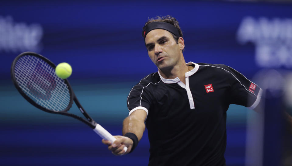 Roger Federer, of Switzerland, returns to Grigor Dimitrov, of Bulgaria, during the quarterfinals of the U.S. Open tennis tournament Tuesday, Sept. 3, 2019, in New York. (AP Photo/Charles Krupa)