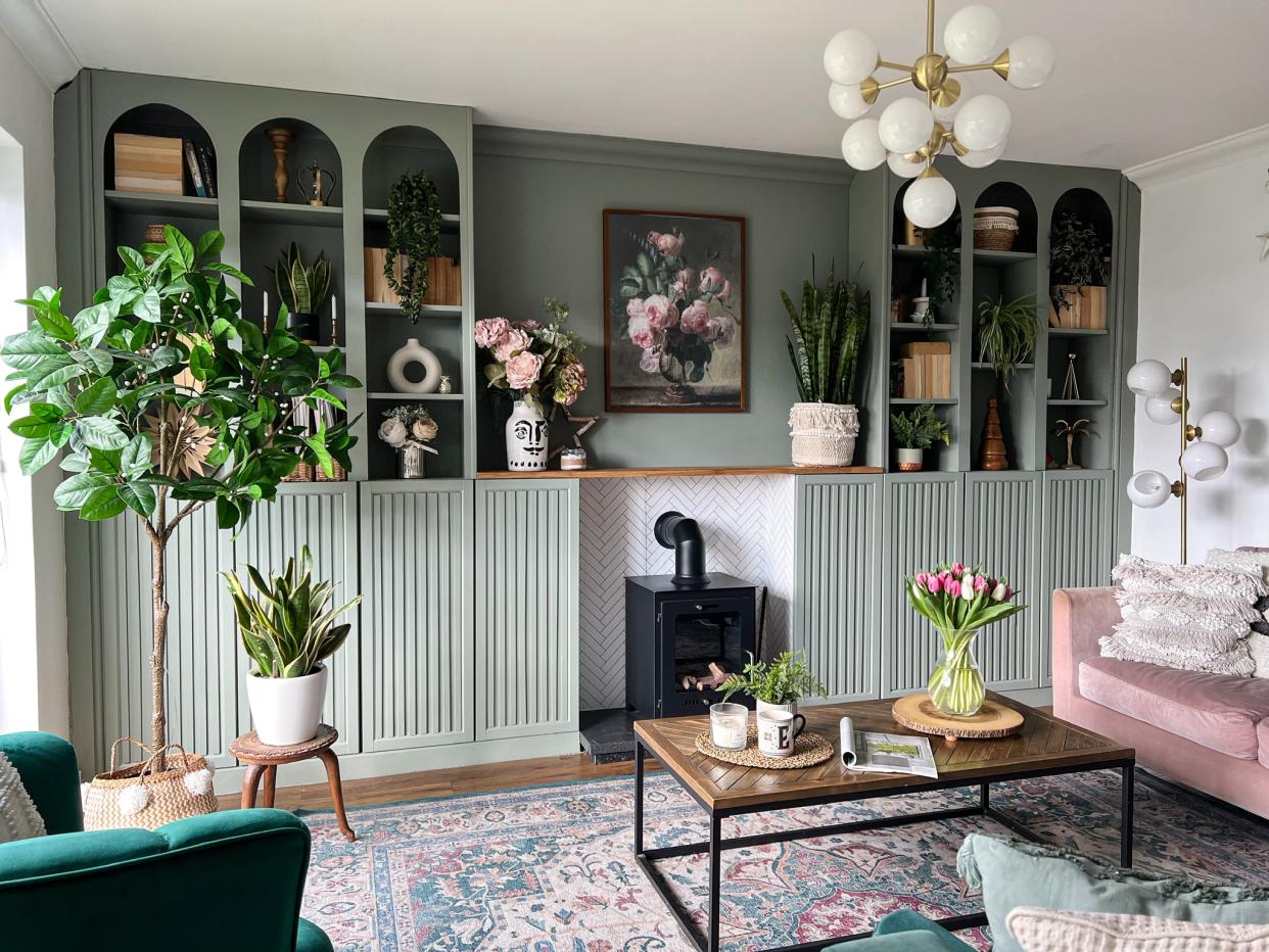  A living room with a built in ikea billy bookcase painted in sage green. 