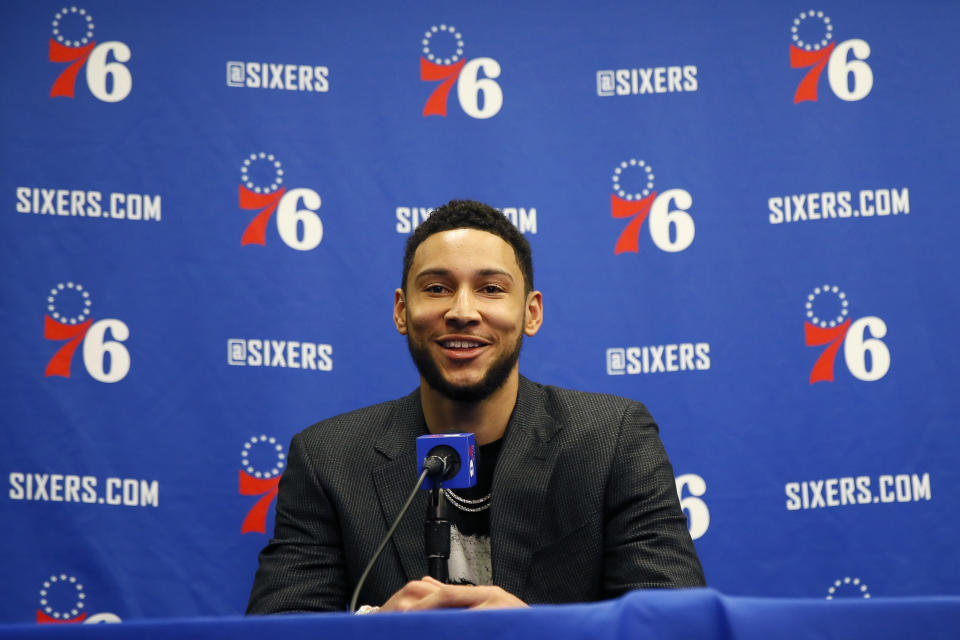 FILE - In this March 11, 2020, file photo, Philadelphia 76ers' Ben Simmons smiles while speaking at a news conference before an NBA basketball game against the Detroit Pistons in Philadelphia. Video games have become a go-to hobby for millions self-isolating around the world, and athletes from preps to pros have eagerly grabbed the controls. Stars like Ben Simmons and Luka Doncic have turned to gaming to stay connected with fans.(AP Photo/Matt Slocum, File)