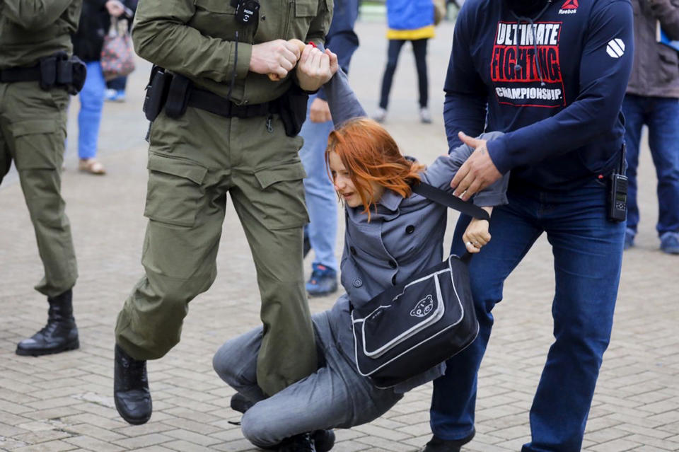 Police officers detain a woman during a rally in support of Maria Kolesnikova, a member of the Coordination Council created by the opposition to facilitate talks with Lukashenko on a transition of power, was detained Monday in the capital of Minsk with two other council members, in Minsk, Belarus, Tuesday, Sept. 8, 2020. A leading opposition activist in Belarus is being held on the border with Ukraine after she resisted attempts by authorities to deport her from the country as part of a clampdown on protests against authoritarian President Alexander Lukashenko. (AP Photo)