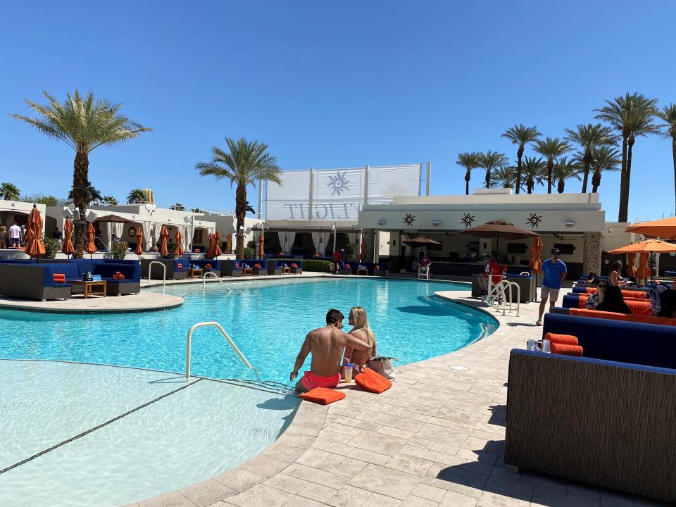 A couple has the pool to themselves at Daylight Beach Club at Mandalay Bay Resort & Casino in Las Vegas.  Pool generally open at 11 a.m. but the crowds don't arrive until later. .