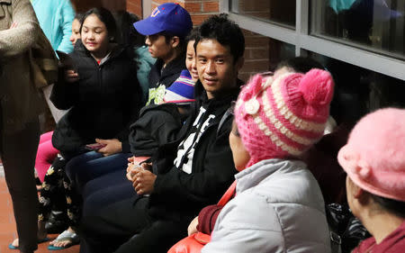 Wimber Htoo and Htoo Lwae Say talk to family members in the Garden City Regional Airport in Garden City, Kansas, U.S., February 15, 2018. REUTERS/Adam Shrimplin