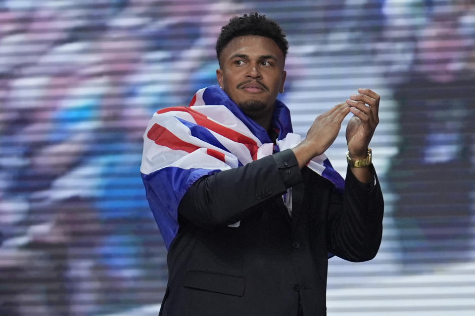 Travis Clayton reacts after being picked by the Buffalo Bills with the 221st overall pick in the seventh round during the third day of the NFL football draft, Saturday, April 27, 2024, in Detroit. (AP Photo/Jeff Roberson)