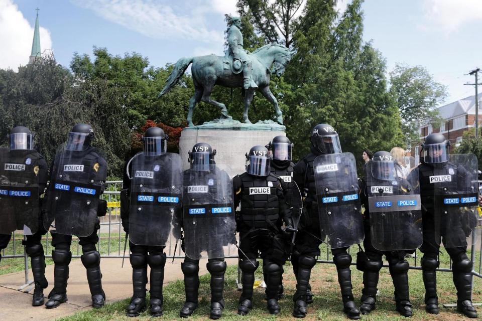 Riot police stand in front of the statue of General Robert E. Lee in Charlottesville (Getty Images)