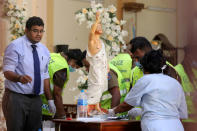 Police officers work at the scene in St. Sebastian Catholic Church, after bomb blasts ripped through churches and luxury hotels on Easter, in Negombo, Sri Lanka April 22, 2019. REUTERS/Athit Perawongmetha
