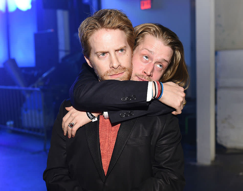 Macaulay Culkin with his arms around Seth Green in 2015