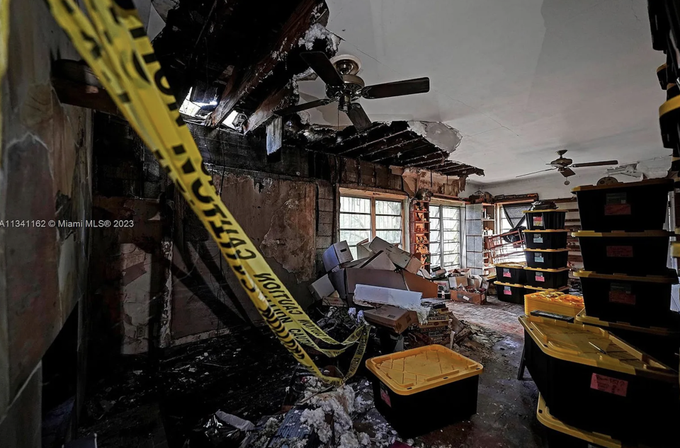 Photos show multiple holes in the home&#39;s ceiling, and debris on its floors.&nbsp; / Credit: Zillow