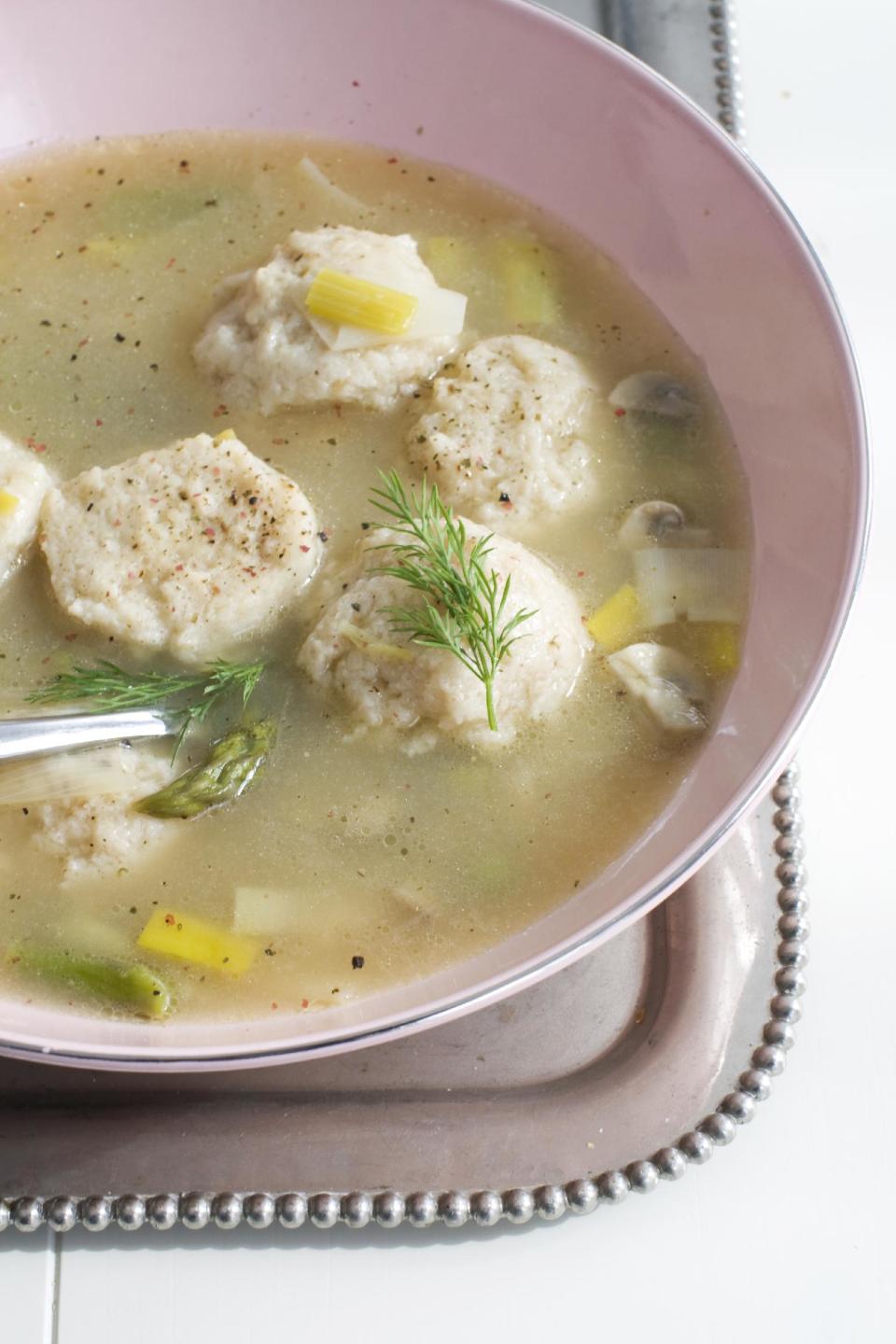 In this March 4, 2013 photo, spring vegetable soup with low-fat, high-flavor matzo balls is shown served in a bowl in Concord, N.H. (AP Photo/Matthew Mead)