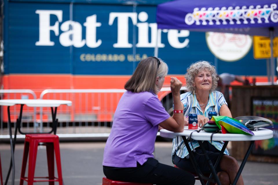 Community members enjoy a Fat Tire from sponsor New Belgium during NoCo Pride in the Park on Saturday, July 16, 2022 at Civic Center Park in Fort Collins.