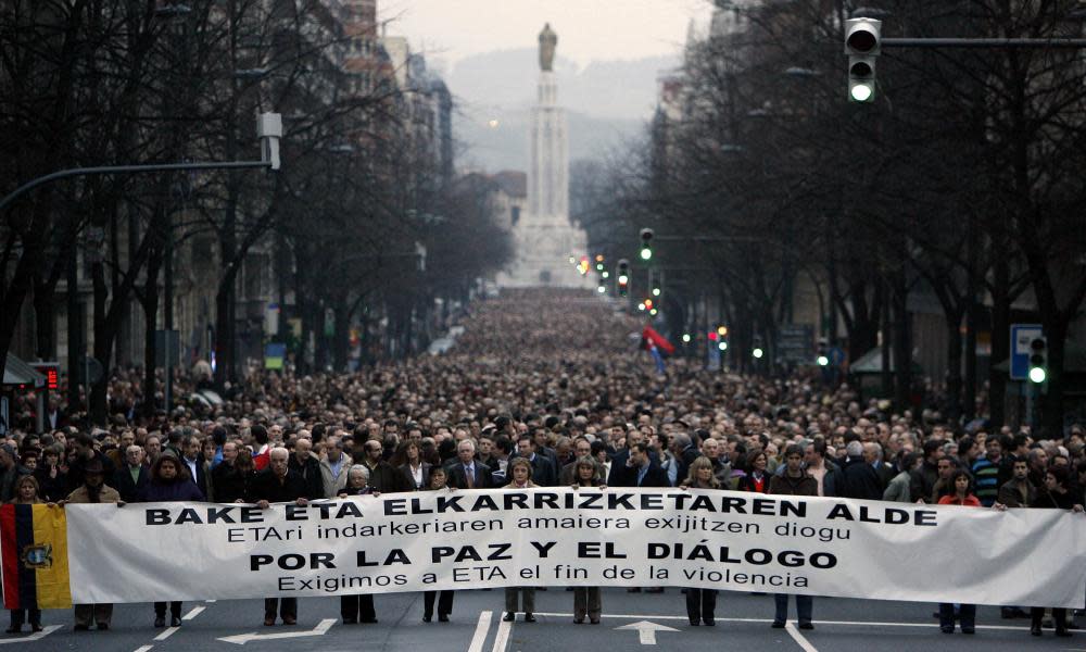 Anti-Eta protesters hold a banner that reads: ‘For the peace and dialogue’ as they walk through central Bilbao, in the Basque country, in January 2007.