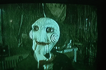 Billy the doll in Jigsaw talks to the camera