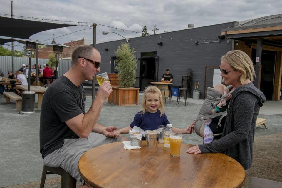 Michael and Heather Wadekamper enjoy Friday afternoon at the SacYard Tap House with their children. The tap house allows children in the outdoor patio and front area.