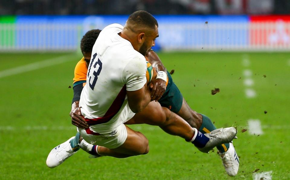 England's Joe Marchant is tackled by Australia's Marika Koroibete during the rugby international between England and the Wallabies in Perth, Australia, Saturday, July 2. - AP