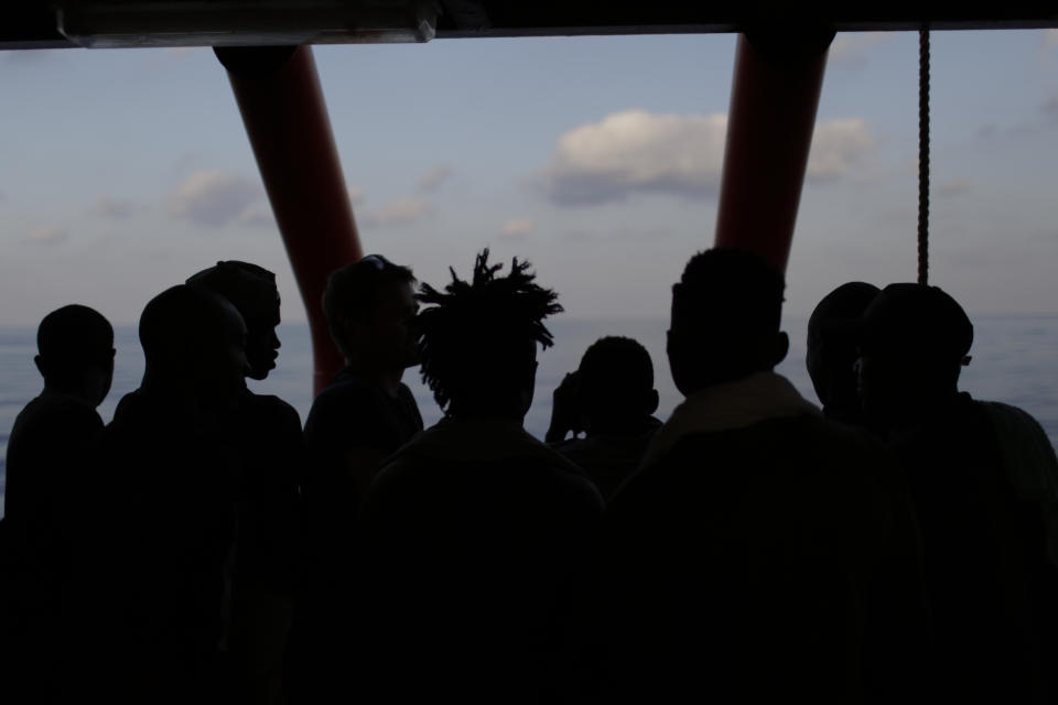 FILE - In this Sept. 13, 2019, file photo, rescued migrants are silhouetted as they look out at the horizon aboard the Ocean Viking, in the Mediterranean Sea. The U.N. refugee agency is investigating why Malta last week allegedly asked the Libyan coast guard to intercept a migrant boat in a zone of the Mediterranean under Maltese responsibility, in possible violation of maritime law, a U.N. official said Tuesday, Oct. 22, 2019. (AP Photo/Renata Brito, File)