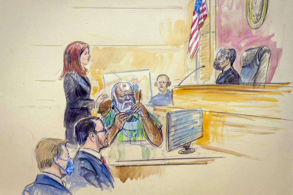 The artist sketch depicts Assistant U.S. Attorney Erik Kenerson, seated from from left, watching as Whitney Minter, a public defender from the eastern division of Virginia, stands to represent Abu Agila Mohammad Mas’ud Kheir Al-Marimi, center, accused of making the bomb that brought down Pan Am Flight 103 over Lockerbie, Scotland, in 1988, in federal court in Washington, Monday, Dec. 12, 2022, as Magistrate Judge Robin Meriweather listens. (Dana Verkouteren via AP)