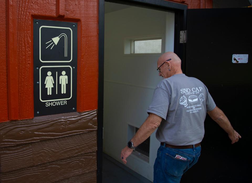 Buddy Blair visits the public restrooms at a park in downtown Sisters that he and his family use to shower during the work week.