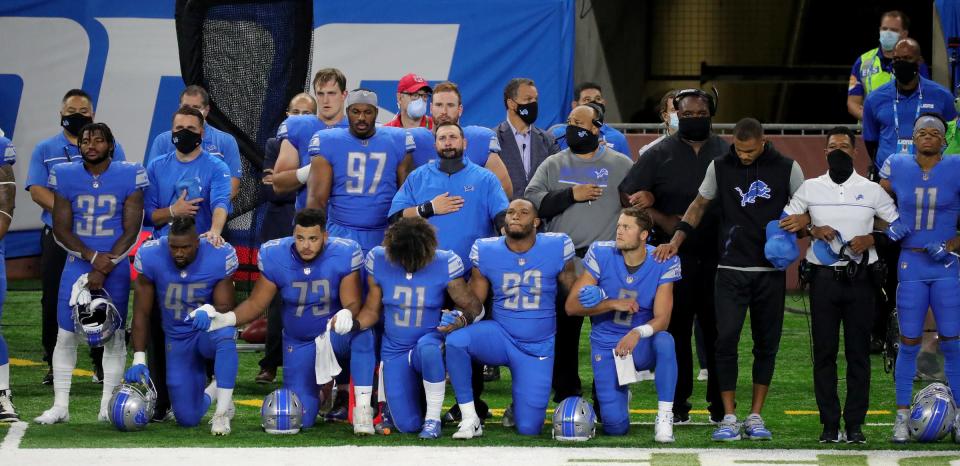 The Lions players take a knee during the anthem before the first half at Ford Field on Sunday, Sept. 13, 2020.