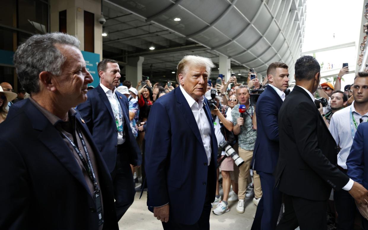Donald Trump walks through the paddock with plenty of security