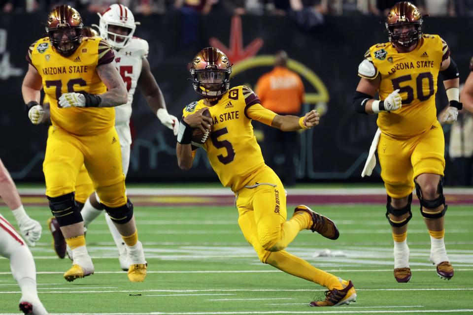 Arizona State quarterback Jayden Daniels (5) runs against Wisconsin during the first half of the Las Vegas Bowl NCAA college football game Thursday, Dec. 30, 2021, in Las Vegas.