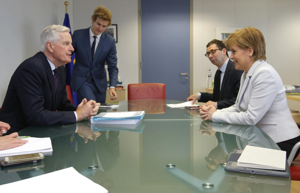 European Union chief Brexit negotiator Michel Barnier, left, speaks with Scotland's First Minister Nicola Sturgeon during a meeting at EU headquarters in Brussels Tuesday, June 11, 2019. (Olivier Hoslet, Pool Photo via AP)