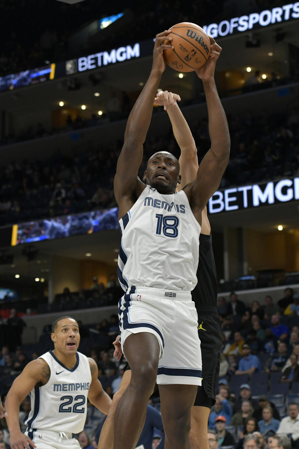 Memphis Grizzlies center Bismack Biyombo (18) grabs a rebound in the first half of an NBA basketball game against the Utah Jazz Wednesday, Nov. 29, 2023, in Memphis, Tenn. (AP Photo/Brandon Dill)