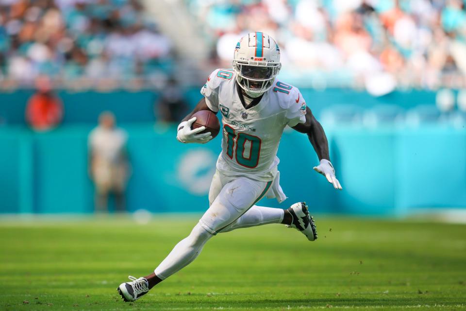 Miami Dolphins wide receiver Tyreek Hill (10) runs with the football against the Carolina Panthers during the second quarter at Hard Rock Stadium.