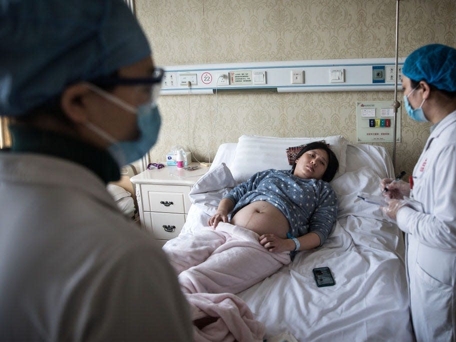 WUHAN, CHINA - FEBRUARY 19: A doctor examines a pregnant woman in a private obstetric hospital on February 19, 2020 in Wuhan, Hubei, China.