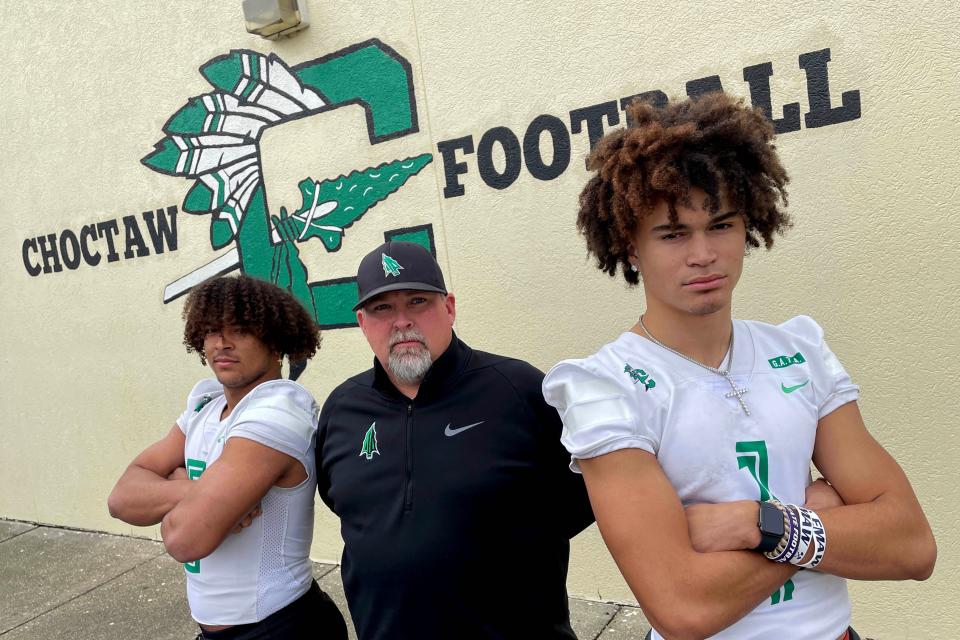 The Daily News football coach of the year Frank Beasley is flanked by Daily News football players of the year, Cole Tabb, left, (offense) and Jayce Brown (defense) at Choctawhatchee High School.